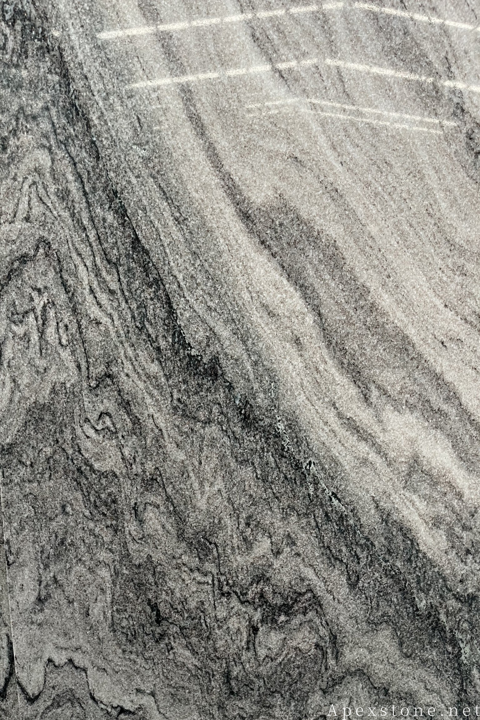 Red Sandalwood marble with dark wood-grain patterning over a soft grey base